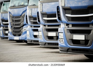 Fleet of commercial lorry trucks in row. Logistics and transportation service - Shutterstock ID 2133930469