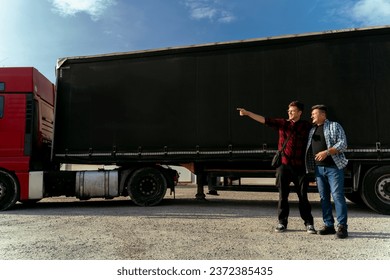 Fleet manager taking to driver, explaining something and pointing 