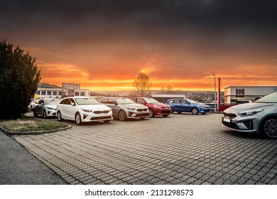 Fleet Of Modern New Stock Vehicles Standing In The Parking Lot Prepared For Carsale During Cloudy Morning Sunrise. Row Of Cars With Different Colors And Sizes Waiting For New Customers.