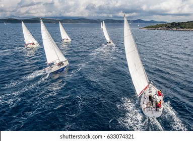 Fleet of sailing boats during offshore race from bird view