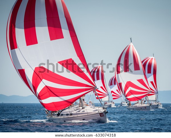 Fleet of sailing boats with spinnaker during\
offshore race