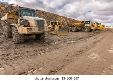 Fleet Of Trucks And An Excavator On A Construction Site