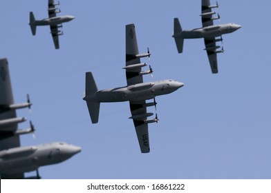 A fleet of USAF transport planes flying overhead. (Shot with minimum depth of field. Focus is on the centre aircraft.)