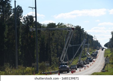 A Fleet Of Utility Vehicles Slow Traffic Along Rt 20 In Ft Braden  Florida , USA. In An Effort To Repair Miles Of Downed Power Lines In The Aftermath Of Cat 5 Hurricane Michael. 8-24-2017