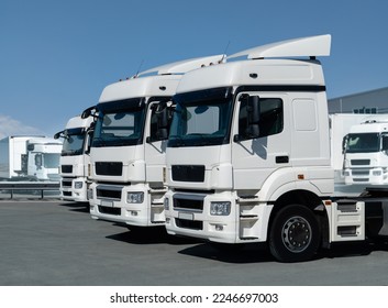 Fleet of white semi trucks in a row - Shutterstock ID 2246697003