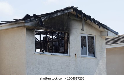 Fleetwood, Lancashire/UK - July 18th 2019: Fire Damaged House On A Suburban Street With Smoke Damage To The Front And Roof