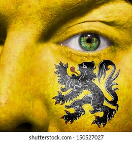 Flemish flag painted on a a man's face to support his region Flanders