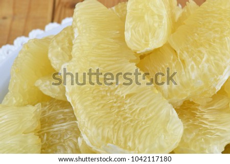 Flesh of fresh yellow pomelo on the wooden background