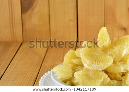 Flesh of fresh yellow pomelo on the wooden background