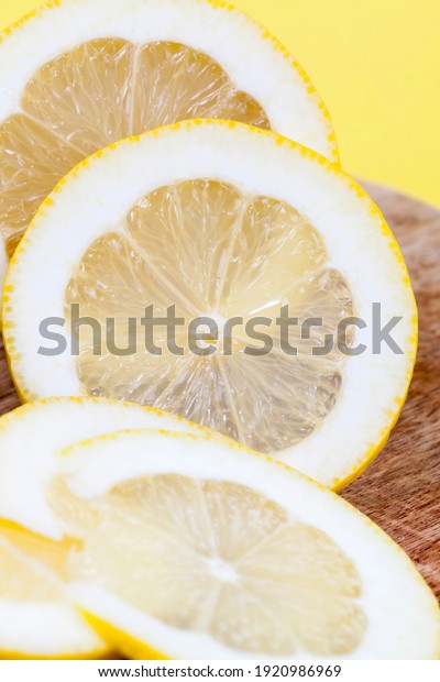 the flesh of
a yellow lemon, cut into several parts, the lemon is sweet and
juicy divided by a sharp object,
closeup