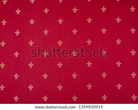 Fleur-de-lis Pattern painted on a red wall. Luxury vinous red and yellow vintage classical
