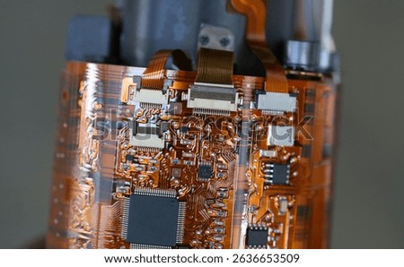 Flex printed circuit board inside dslr camera lense, FPC cables connected to PCB through socket. copper layer and surface mounted electronic components. 