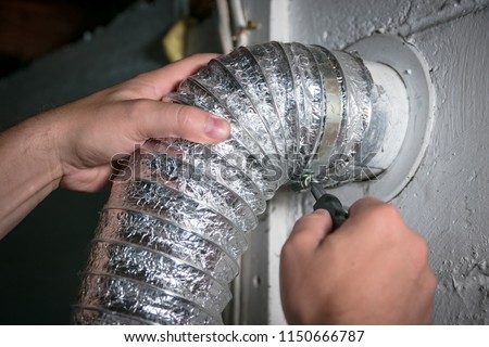Flexible dryer vent hose, attaching/detaching from wall vent by turning screw in steel duct clamp.