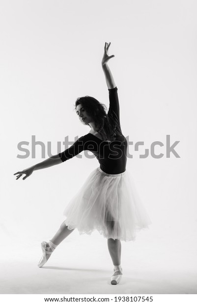 Flexible female, ballet dancer in black\
bodysuits, ballerina