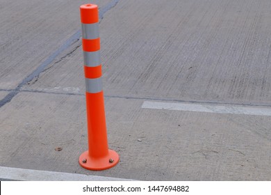 flexible orange PVC delineator post instored on the road for traffic sign gears - Shutterstock ID 1447694882