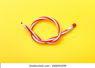 Flexible pencil on a yellow background. Bent pencils two-color - Shutterstock ID 1006953598