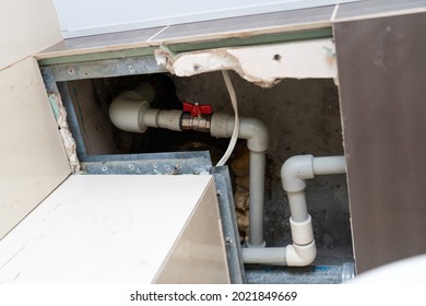 Flexible Plastic Pipe In The Hatch In The Ceiling. Replacement Of The Riser And Pipes Through The Tiles Cut In The Ceiling. Red Ball Valve On A Pex-Al-Pex Pipe With Union Nut, Sleeve Nut In A