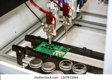 Flexible robotic conformal coating and dispensing system for selective coating potting, bead, and meter-mix dispensing applications - Shutterstock ID 1107872066