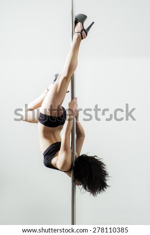 Flexible Sexy Woman Dancing In Black Lingerie On The Pole On White Background Copyspace Vertical Flexible Sexy Woman Dancing In Black Lingerie On The Pole On White Background Copyspace Vertical