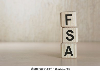 Flexible Spending Account FSA Written On A Wooden Cubes.