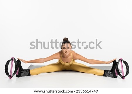 flexible woman exercising on fitness mat while wearing  kangoo jumping shoes, motivation, warm up