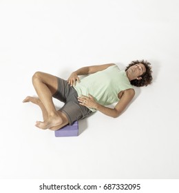 Flexible Yoga Man Lying Down In External Rotation Or Double Pigeon Pose Agnistambasana