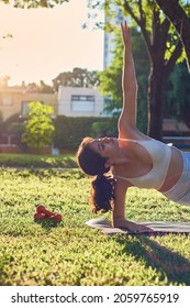 Flexible Young Latina Woman Practicing Yoga In The Park