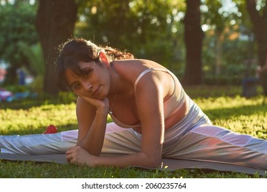 Flexible Young Latina Woman Practicing Yoga In The Park