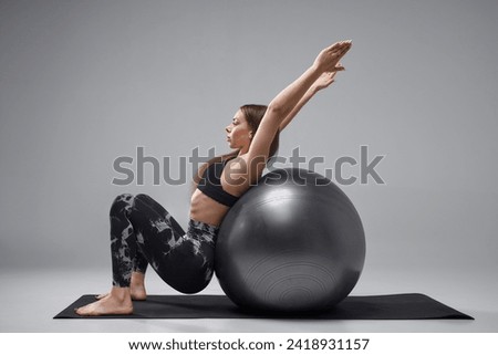 Similar – Image, Stock Photo Slim female doing side plank star pose during yoga session in park