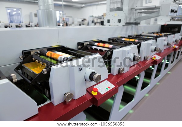 Flexographic printing machine with an ink tray,\
ceramic anilox roll, doctor blade and a print cylinder with polymer\
relief plate stuck on it. In-line press machine. Rotary or Flexo\
printing machine.
