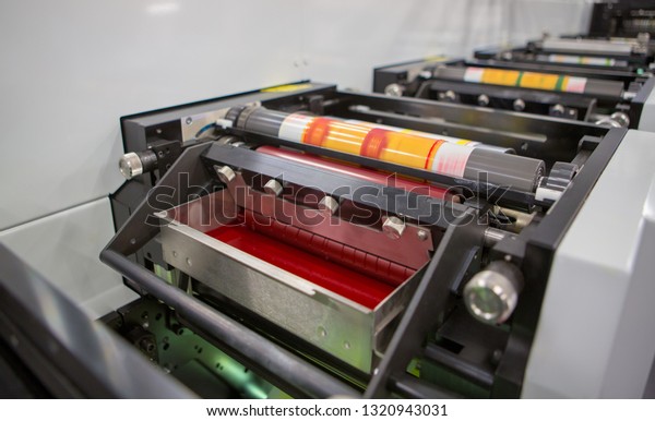 Flexographic printing machine with an ink tray,\
ceramic anilox roll, doctor blade and a print cylinder with polymer\
relief plate stuck on it. In-line press machine. Rotary or Flexo\
printing machine.