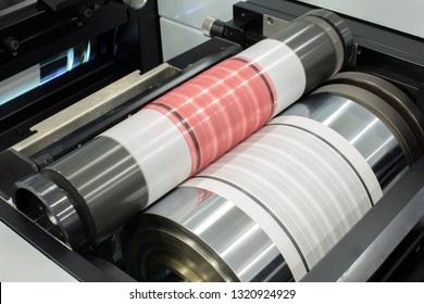 Flexography Printing Process On In-line Press Machine. Photopolymer Plate Stuck On Printing Cylinder, Substrate Is Sandwiched Between The Plate And The Impression Cylinder To Transfer The Ink.