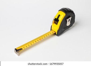 flexometer of black and yellow color with the measurement scale extended isolated on white background