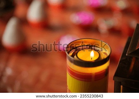 Flickering candles offering to the gods and Buddha burns at the altar in a chinese temple. Sacrificial ceremonies for traditional festivals and holy days.