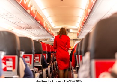 Flight Attendant Serve Food And Drinks To Passengers On Board