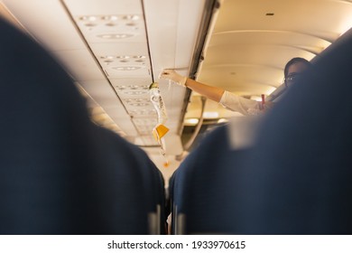 Flight Attendant Showing How To Use Oxygen Mask Before Taking Off.