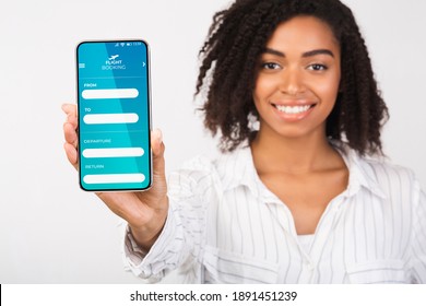 Flight Booking App Opened On Smartphone In Black Female Hand, Smiling African Lady Holding Mobile Phone With Air Tickets Reservation Website On Screen, Recommending Services, Creative Collage