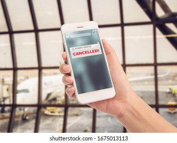 Flight Cancellation Concept. Announces Message For Flight Schedule Change Information Alert On Smartphone Application With Airport Terminal At Background. 