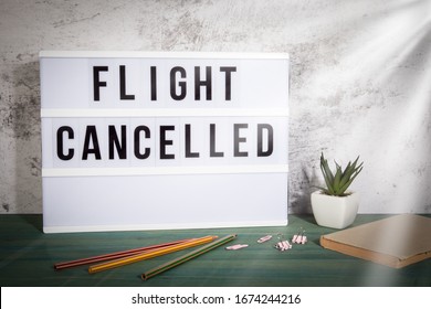 Flight Cancelled. Travel Plans, Disaster, Crisis, Quarantine And COVID-19 Concept.  White Lightbox On A Wooden Table