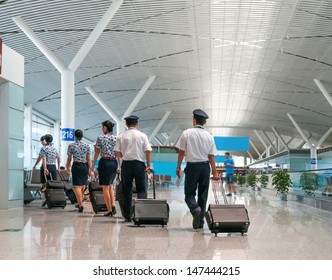 A Flight Crew Walking In The Airport