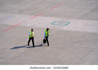 Flight Crew Walking Outdoors Of Zürich Airport On A Sunny Spring Day. Photo Taken March 26th, 2022, Zurich, Switzerland. 