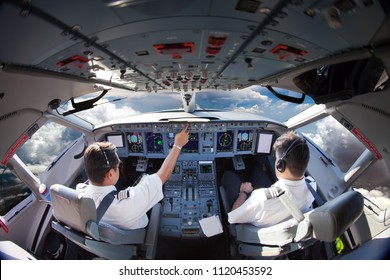 Flight Deck of modern aircraft. Pilots at work. Clouds view from the plane cockpit.