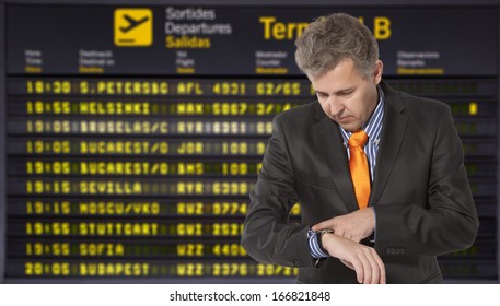 Flight Delay. Businessman Looking At His Watch 