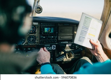 Flight Instructor And Student Reviewing Flight Checklist 