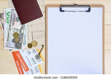 Flight Itinerary  Long Weekend, Travel Plan Schedule Concept : Top View  Flat Lay Of White Empty  Blank Paper On Clipboard, US Dollar Money, Coins, Passport, Boarding Passes, Key, Calendar On Table