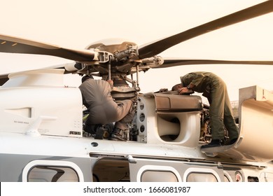 Flight maintenance inspect main rotor hub of helicopter.