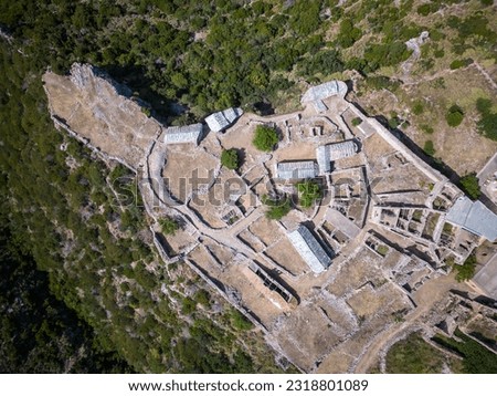 Flight over ancient Mylopotamos Castle Kato Chora on the island of Kythira with settlement remains and ancient town