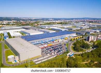 Flight Over Modern Storage Warehouse With Solar Panels On The Roof. Industrial Zone And Technology Park On Bory Suburb Of Pilsen City, Czech Republic, Europe.