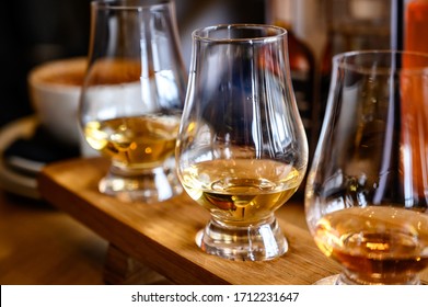 Flight of Scottish whisky, tasting glasses with variety of single malts or blended whiskey spirits on distillery tour in Scotland, UK