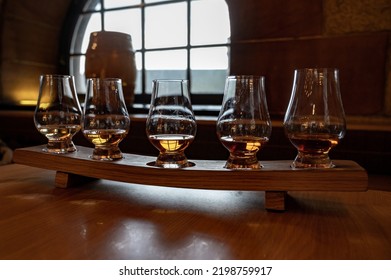 Flight Of Single Malt Scotch Whisky In Glasses Served In Bar In Edinburgh, UK, Tasting Of Dram Of Whiskey